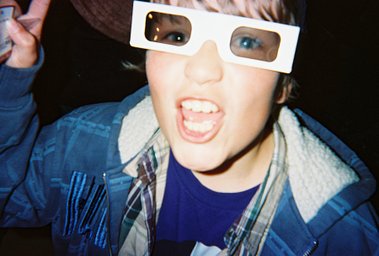 A candid night-out photo of a person wearing 3D glasses